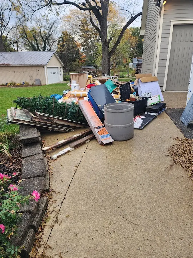 Dumpster being loaded with debris for Estate Cleanout Dumpster Rental in Port St. John